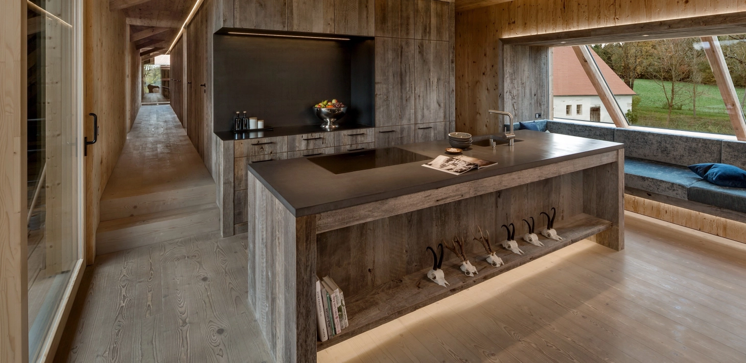 Kitchen in a wood-clad home with concrete worktop