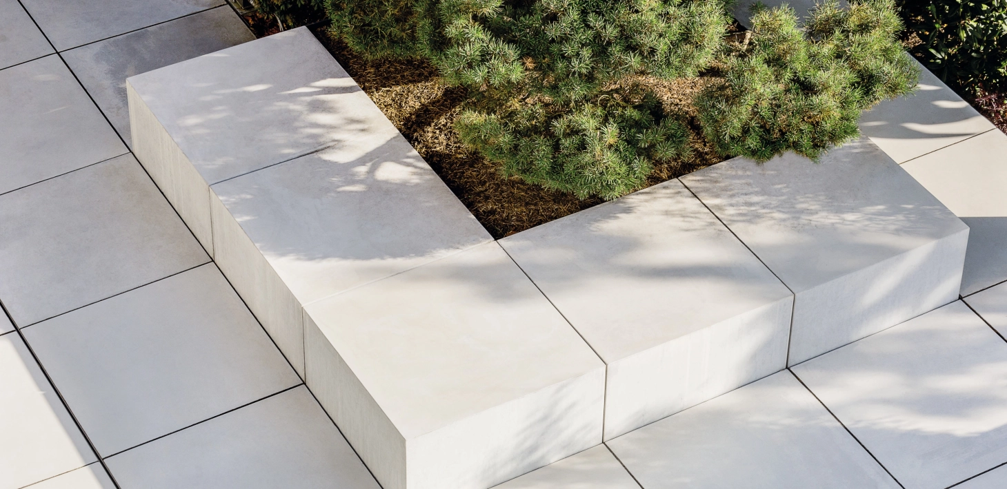 Seat block and terrace slabs made of gray exposed concrete