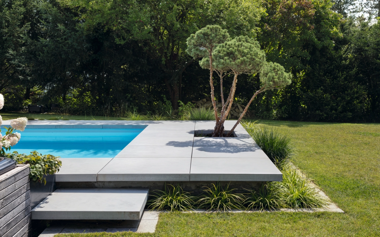 Pool mit großen Terrassenplatten und Schwebestuf