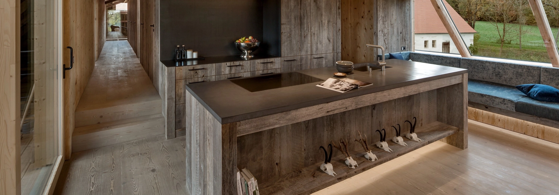 Kitchen in a wood-clad home with concrete worktop