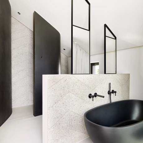 Bathroom with herringbone-patterned wall tiles