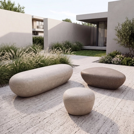 Betonelemente Sitzelemente aus Beton in großer Kieselsteinform als Highlight für den Garten